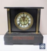 A Victorian black slate mantel clock with brass and enamelled dial