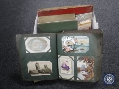 A box of three antique postcards albums and a small quantity of loose postcards