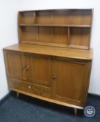 An Ercol elm triple door sideboard with display rack