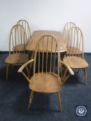 An Ercol elm drop leaf kitchen table and five chairs (one carver,