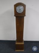 An oak granddaughter clock with silvered dial