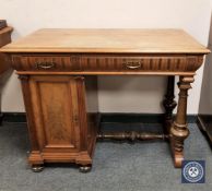 A continental walnut single pedestal writing desk with understretcher,