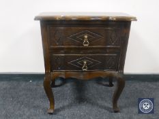 A continental carved oak bedside chest