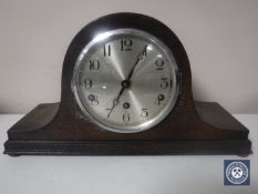 A 20th century oak cased mantel clock with silvered dial