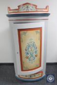 A continental polychrome painted corner cupboard fitted a drawer