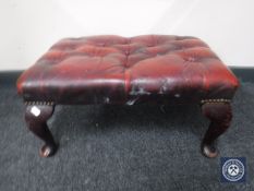 A red button leather Chesterfield footstool