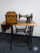 A mid 20th century Singer treadle sewing machine in oak table