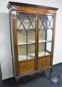 A Victorian inlaid mahogany display cabinet