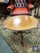 A mahogany shaped occasional table on tripod base,