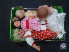 A crate of dolls and a doll's head.