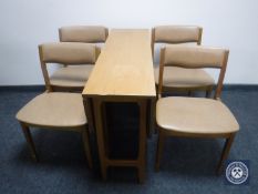 A teak drop leaf table and four chairs