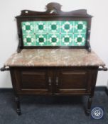 A Victorian mahogany marble topped tiled back wash stand