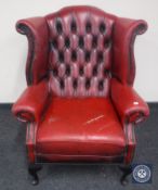 A red button leather Chesterfield wingback armchair