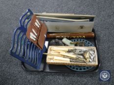 A tray of cased Hohner Melodica, tourist truncheon, fish cutlery, cast iron trivet with menu stand,