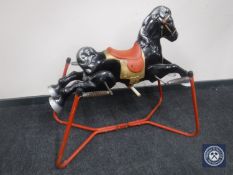 A mid 20th century Mobo tin horse on spring base