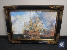 An ebonised and gilt framed print depicting a naval battle