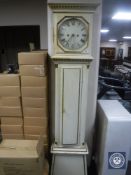 An antique continental cream and gilt longcase clock