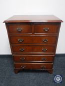 A reproduction seven drawer chest