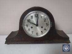 A 20th century oak cased mantel clock with silvered dial