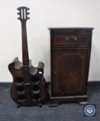 A CD cabinet and a six bottle wine rack in the form of a guitar