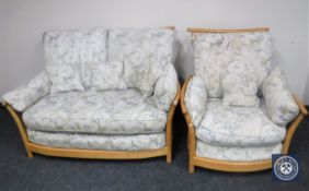 A beech framed three seater Ercol settee and matching armchair