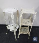 A painted cast metal plant stand and similar trivet stand