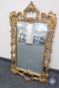 A highly ornate gilt framed mirror