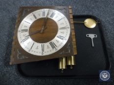 A continental Gensa oak cased wall clock with pendulum,