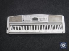 A Yamaha portable grand DGX-300 electric keyboard,