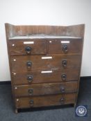 An Edwardian oak six drawer chest with metal drop handles