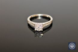 A platinum and diamond cluster ring set with diamond shoulders, size K 1/2.