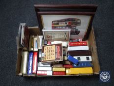 A box containing a large quantity of boxed and unboxed die cast buses together with two framed bus
