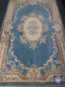 A fringed woollen Chinese rug on blue ground