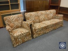 A mid 20th century three seater settee and armchair in floral fabric