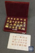 A set of silver gilt 'Empire Collection' stamps in presentation case.