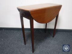 A George IV mahogany drop leaf table fitted a drawer