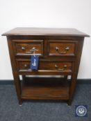 A reproduction side table fitted three drawers