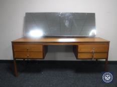 A mid 20th century teak kneehole dressing table fitted four drawers