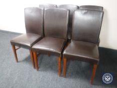 A set of six brown leather upholstered dining chairs