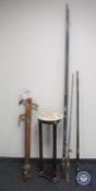 A bundle of walking sticks together with a mahogany plant stand and three two-piece fishing rods