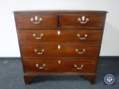 A George III mahogany five drawer chest on bracket feet