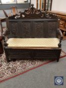 A Victorian carved oak hall seat,