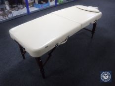 A folding Master massage table in carry bag