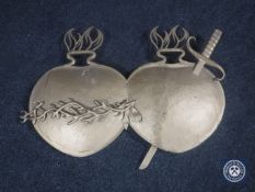 A cast metal double heart coat of arms