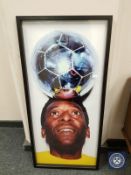 A colour photograph depicting Pele with a football balanced on his head,