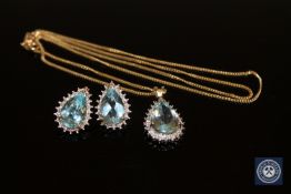 A 9ct gold blue topaz and diamond set pendant with matching earrings.