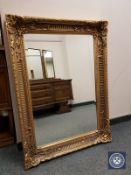 An ornate gilded bevelled mirror,