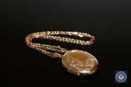 A 9ct gold locket suspended upon a 9ct gold chain.