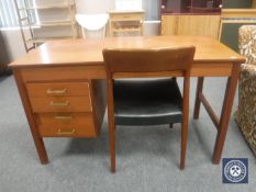 A mid 20th century teak desk and a leather seated chair