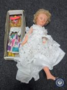 A box of mid 20th century doll in white dress and a boxed Pelham puppet